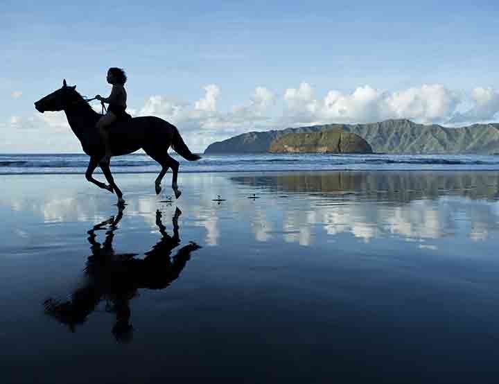 Horse riding on Hiva Oa beach - Marquesan island